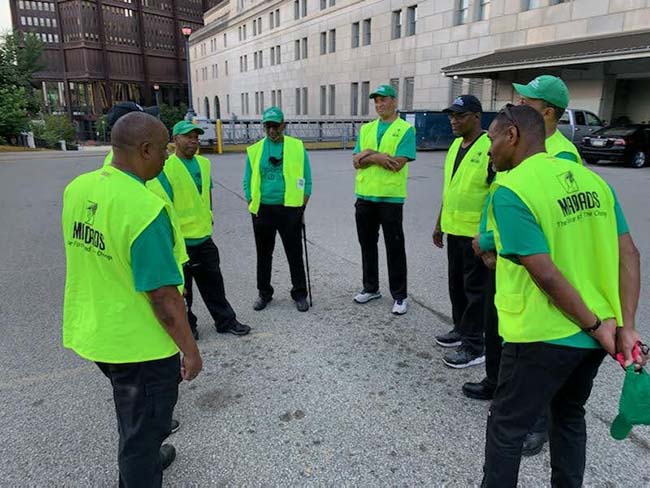 MAD DADS Street Patrol members gathering for a briefing before an evening walk in Pittsburgh